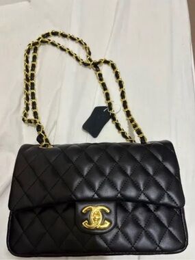 CHANEL Black Quilted Shoulder Bag with Gold Chain and CC Turnlock